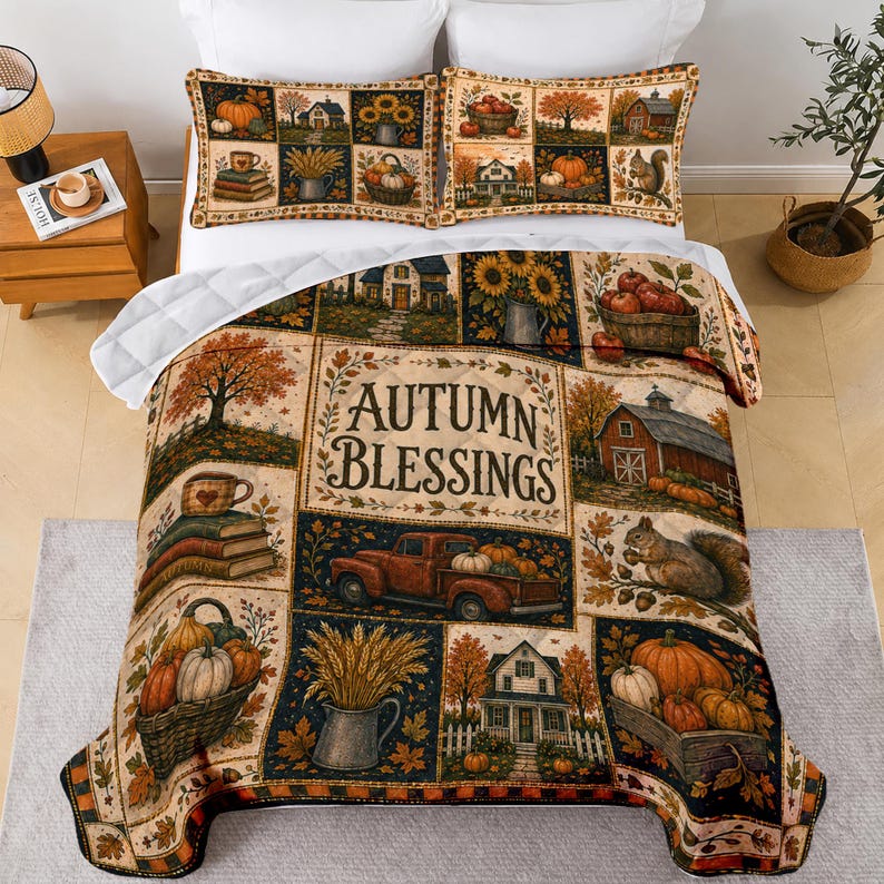 May include: A quilt and two pillowcases featuring a patchwork design with autumn-themed illustrations including pumpkins, a red truck, a barn, squirrels, and books. The central panel displays the text "AUTUMN BLESSINGS" in a dark brown font.