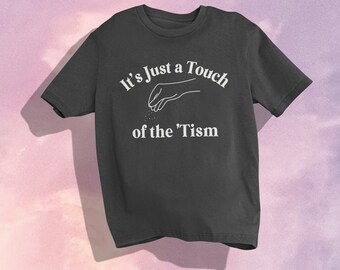 May include: A dark gray t-shirt with a white graphic of a hand sprinkling something with the text "It's Just a Touch of the 'Tism"