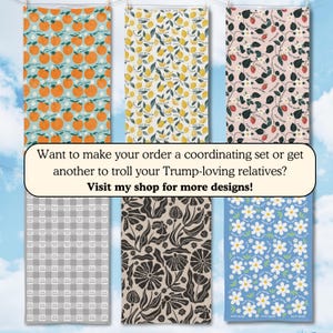 May include: Collection of six decorative towels with various patterns. Designs include oranges on teal, lemons on yellow, strawberries on pink, a gray checkered pattern, black floral, and white daisies on blue. The text on the towels reads "F*ck Trump".