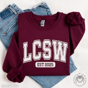 May include: Maroon sweatshirt with white text that reads "LCSW EST 2025".