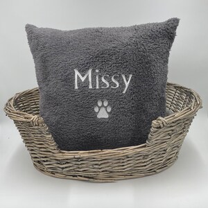 May include: Gray plush dog bed with a gray and white embroidered pillow that says "Missy" with a paw print.