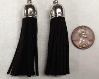 May include: Two black tassel trim with silver metal tops. The tassels are about 2 inches long.