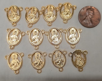 May include: A set of 12 gold-toned metal charms featuring a religious image of Jesus Christ. Each charm has three loops for attaching to a necklace or bracelet.