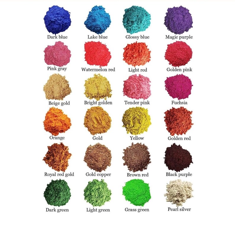 May include: A collection of 18 small piles of colored sand, each labeled with a color name. The colors include dark blue, lake blue, glossy blue, magic purple, pink gray, watermelon red, light red, golden pink, beige gold, bright golden, tender pink, fuchsia, orange, gold, yellow, golden red, royal red gold, gold copper, brown red, black purple, dark green, light green, grass green, and pearl silver.