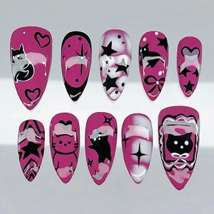 May include: A set of ten almond-shaped, press-on nails in a vibrant magenta hue. Each nail features unique designs, including black cats, stars, hearts, and abstract patterns. Some nails have a marbled effect with white and gray accents, creating a playful and stylish look.