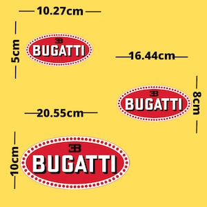 May include: Three red and white Bugatti logo decals. The largest is 20.55cm long and 10cm high. The medium decal is 16.44cm long and 8cm high. The smallest is 10.27cm long and 5cm high. All have a white border with red dots.