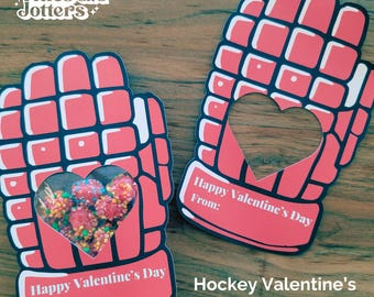 May include: Two printable Valentine's Day cards shaped like hockey gloves. The cards have a heart-shaped cutout to hold candy or a small gift. The text on the cards reads "Happy Valentine's Day" and "From:".