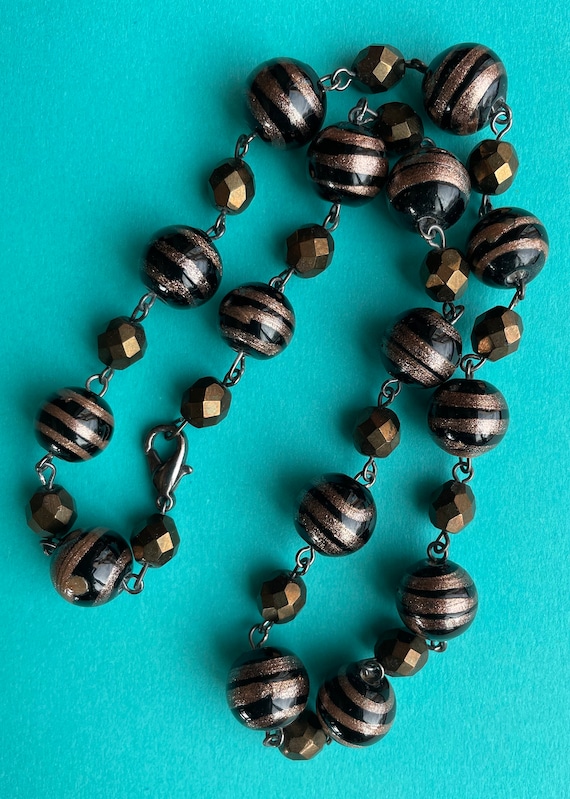 Art Deco era Venetian art glass beads in black swi