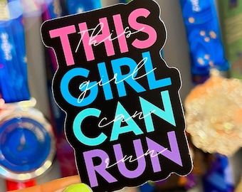 May include: A black sticker with the text "This girl can run" in pink, blue, and purple letters. The sticker is held in a hand with green nail polish.
