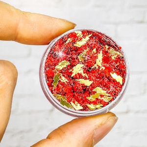 May include: A small clear jar filled with red glitter and gold glitter shaped like lightning bolts.