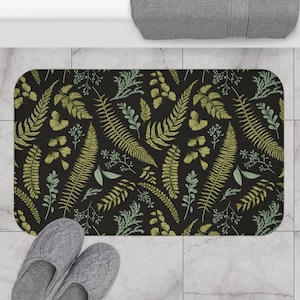 May include: A black bath mat with a green and white fern pattern.