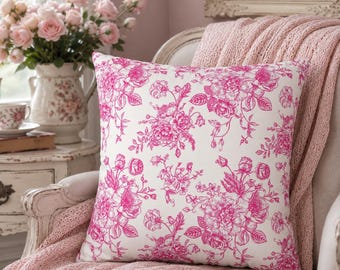 May include: A square throw pillow featuring a white fabric base with a repeating hot pink floral pattern of roses and leaves. The design displays detailed botanical illustrations of blooming flowers and buds across the entire surface of the pillow.