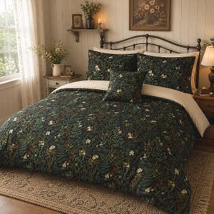 May include: A bedding set featuring a dark green duvet cover and matching pillow shams adorned with a detailed botanical print of ferns, wildflowers, and small berries. The set includes a square accent pillow and a solid cream-colored flat sheet.