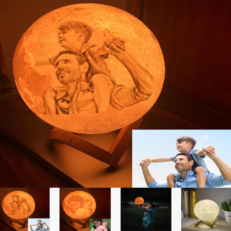 May include: A 3D printed moon lamp with a photo of a father and son printed on the surface. The lamp is lit up and has a warm glow. The lamp is on a wooden stand.