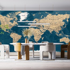 May include: A dining room featuring a large world map mural in shades of blue and tan. A white oval table is surrounded by modern chairs in white, tan, and brown. Decorative plants and lighting fixtures complete the scene.