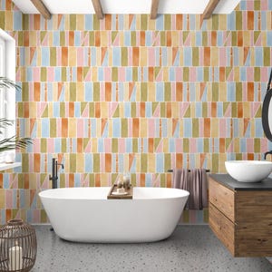 May include: A bathroom with a white bathtub, a wooden vanity, and a round mirror. The walls are covered in a colorful geometric pattern of rectangles and triangles in pastel shades of orange, pink, blue, and green.