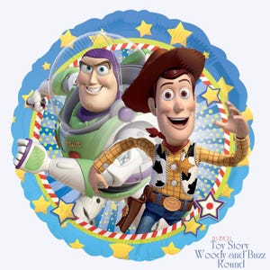 May include: A round foil balloon featuring Buzz Lightyear and Woody from Toy Story. Buzz is in a green and white spacesuit, and Woody wears a cowboy hat and vest. The balloon has a blue border with yellow stars and the text "18 inch Toy Story Woody and Buzz Round".