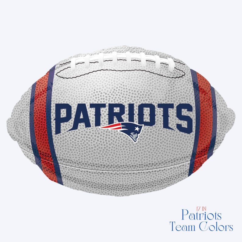 May include: A football with the word "PATRIOTS" in navy blue block letters. The team logo is below the word. The football is white with red and navy blue stripes on the sides. The text "17 IN Patriots Team Colors" is at the bottom.