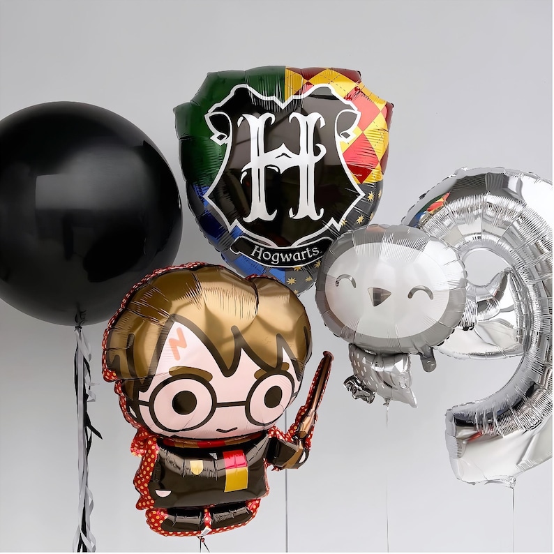 May include: A set of Harry Potter themed balloons, including a black balloon, a silver balloon shaped like a number nine, a silver balloon with a cartoon owl, a balloon with the Hogwarts crest and the text "Hogwarts", and a balloon with a cartoon image of Harry Potter.