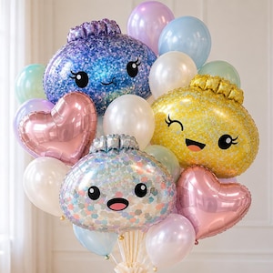 May include: A balloon bouquet featuring three large foil balloons with cartoon faces in blue, yellow, and iridescent silver, accompanied by smaller heart-shaped metallic pink balloons and round latex balloons in pastel shades of white, blue, and purple.