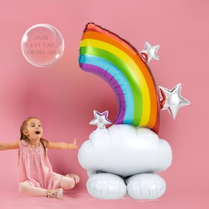May include: A large rainbow balloon arch with a cloud balloon and silver star balloons. The rainbow balloon is over 4 feet tall and is air-fill only.
