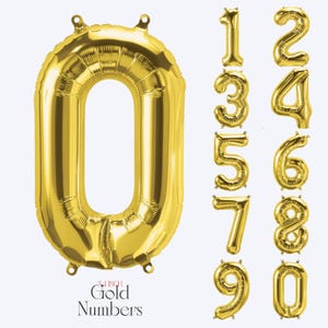 May include: A collection of metallic gold foil balloons shaped as numbers zero through nine. Each balloon features small tabs at the top and bottom for hanging. The text 34 INCH Gold Numbers is printed at the bottom of the large zero balloon.