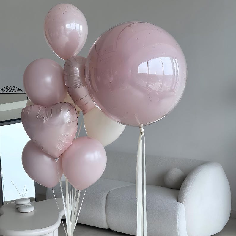 May include: A collection of pink balloons, including round and heart-shaped designs, with white ribbons. The balloons vary in size and shade, creating a soft, celebratory aesthetic. Some balloons have a glittery appearance.