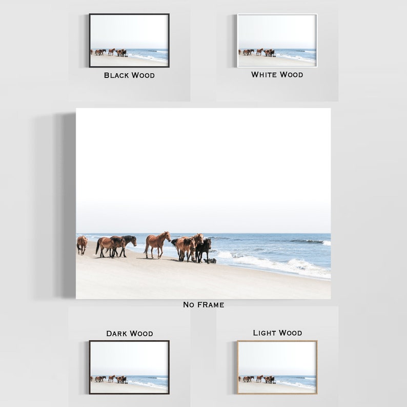 May include: A framed print featuring a serene beach scene with a herd of wild horses. The horses, in shades of brown and black, are gathered near the water's edge. The print is available in black, white, dark, and light wood frames, as well as unframed.