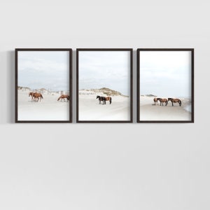 May include: A set of three framed prints featuring brown horses on a white sandy beach. The horses are standing and walking on the beach, with the ocean in the background.