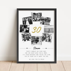 May include: A framed black and white photo collage with the number "30" in gold. The collage includes several small photos and text that reads "Simon" and a birthday message. The frame is rectangular and sits on a light-colored wooden surface.