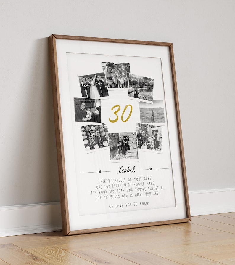 May include: A framed print with a wooden frame. The print features a collage of black and white photos surrounding the gold number "30". Below the photos is the name "Isobel" and a poem about turning thirty. The print is leaning against a white wall.
