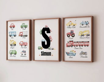 May include: Three framed prints with watercolor illustrations of various vehicles. The center print features the letter "S" in black with the name "Simon" below it. The left print shows a car, truck, bus, digger, fire truck, bin lorry, and ambulance. The right print shows a pickup truck, convertible car, tractor, cement mixer, steam train, boat, and motorbike.