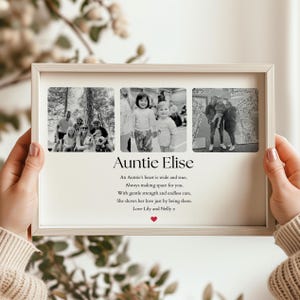 May include: A light-coloured framed photo collage featuring three black and white images. The text "Auntie Elise" is below the photos, with a poem and a heart symbol. The frame is held by hands.