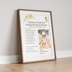 May include: Framed print with a wooden frame. The print features text that reads "Thank you, Emily Our Wonderful Nursery Worker" with a photo of a child. Floral accents in yellow and green decorate the top corners.