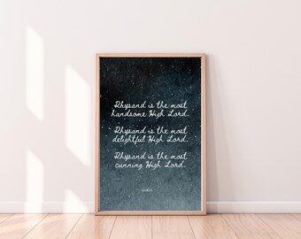 May include: A framed print with a wooden frame displays text on a dark blue and white background. The text reads, "Rhysand is the most handsome High Lord. Rhysand is the most delightful High Lord. Rhysand is the most cunning High Lord."