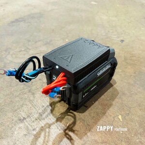 May include: Black and green Zappy Powerbank with a 6.0 Ah 1920W rating. The power bank has a black top with a white light and is connected to wires with blue and red insulation.