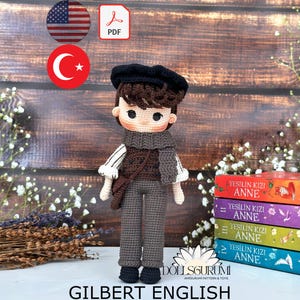 May include: Crochet pattern for a boy doll named Gilbert English. The doll is wearing a brown vest, grey pants, and a black beret. The pattern is available as a PDF download.