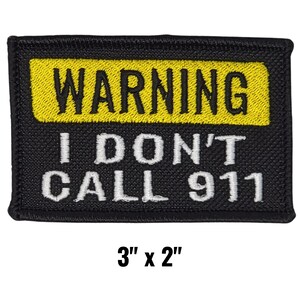 May include: Black rectangular patch with yellow and white text. The yellow section at the top reads "WARNING" in bold black letters. Below, the white text reads "I DON'T CALL 911". The patch measures 3 inches by 2 inches.