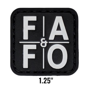 May include: A black square patch with rounded corners. The patch features the white text "FIA & FIO" arranged in two rows, separated by a horizontal line and a vertical line. The patch measures 1.25 inches.