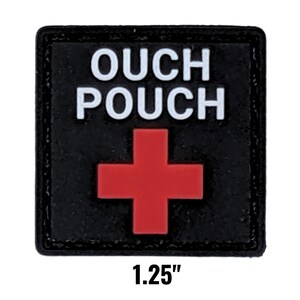 May include: A black square patch with the words "OUCH POUCH" in white block letters above a red cross. The patch measures 1.25 inches.