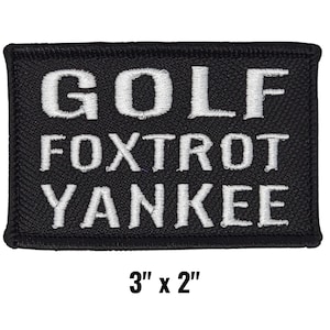 May include: Black rectangular patch with white embroidered text: "GOLF", "FOXTROT", and "YANKEE". The patch measures 3" x 2". The patch has a black border and is likely for a golf enthusiast.