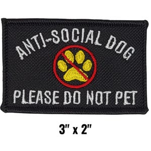 May include: Black rectangular patch with white embroidered text that reads "ANTI-SOCIAL DOG PLEASE DO NOT PET." A yellow paw print is inside a red circle with a red line through it. The patch measures 3" x 2".