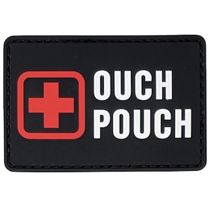 May include: Black rectangular patch with a red cross inside a red square on the left and the words "OUCH POUCH" in white, bold letters on the right. The patch has a black border.