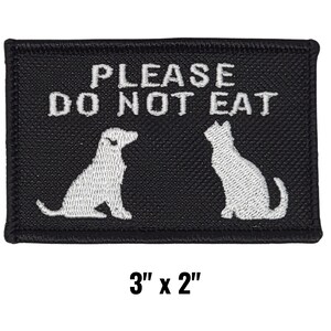 May include: Black rectangular patch with white text that reads "PLEASE DO NOT EAT". The patch features white silhouettes of a dog and a cat. The patch measures 3 inches by 2 inches.