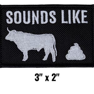 May include: Black embroidered patch with the text "SOUNDS LIKE" above a white bull and a pile of white feces. The patch measures 3 inches by 2 inches.