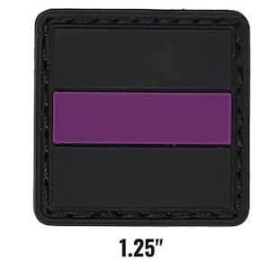 May include: A square black patch with a purple horizontal stripe. The patch measures 1.25 inches across. The edges of the patch are stitched with a black thread.