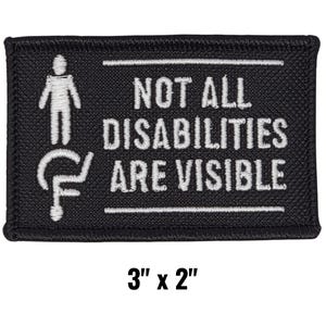 May include: Black rectangular patch with white text and symbols. The text reads "NOT ALL DISABILITIES ARE VISIBLE." The patch also features a stick figure and a wheelchair symbol. The patch measures 3 inches by 2 inches.