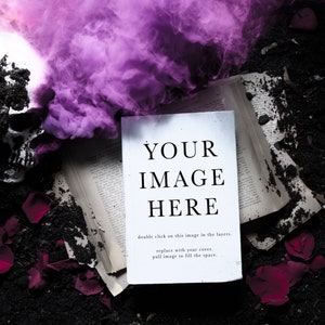 May include: A white book mockup with the text "YOUR IMAGE HERE" on a black background with a skull, pink smoke, and red rose petals.