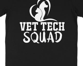 May include: Black t-shirt with a white graphic featuring a heart-shaped design with a cat and dog silhouette, and the words "VET TECH SQUAD" in bold, white letters. The shirt is made of a soft material.