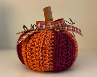 A maroon and orange crochet pumpkin